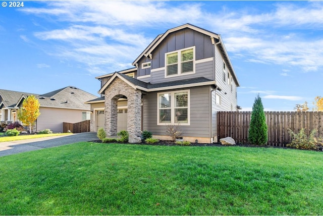 craftsman inspired home featuring a front yard and a garage