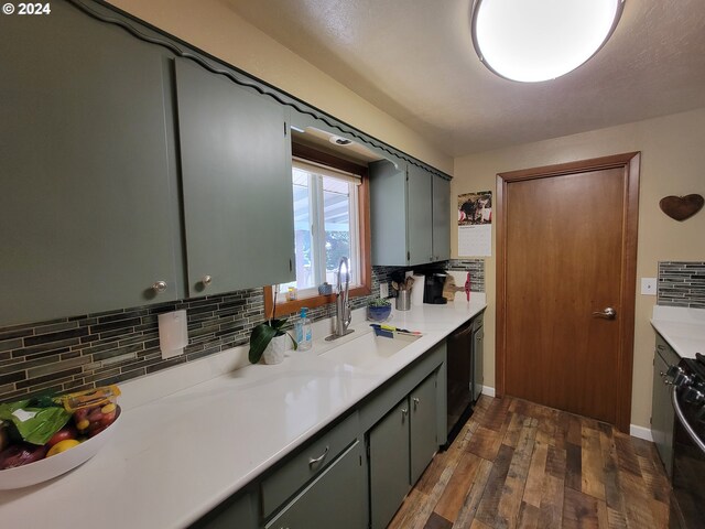 kitchen featuring black appliances, backsplash, sink, and dark hardwood / wood-style flooring