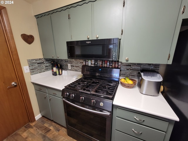 kitchen featuring backsplash, dark wood-type flooring, and stainless steel range with gas stovetop