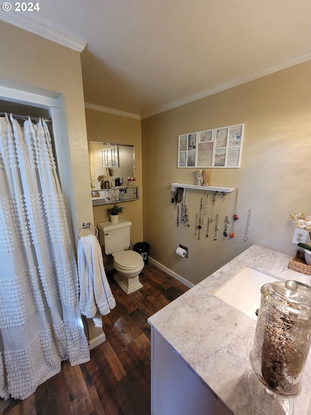 bathroom with ornamental molding, vanity, hardwood / wood-style floors, and toilet