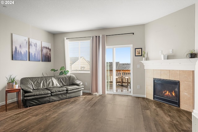 12948 SE 155th Ave, Happy Valley, OR 97086 - living room with dark wood finished floors, a tile fireplace, and baseboards