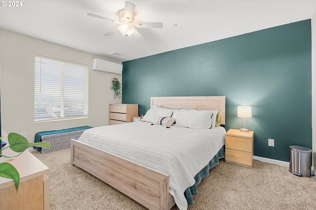 bedroom featuring ceiling fan, light colored carpet, and a wall unit AC