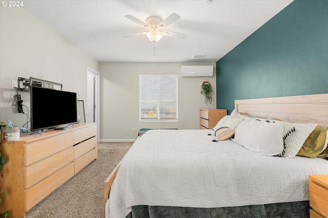 carpeted bedroom with ceiling fan and an AC wall unit