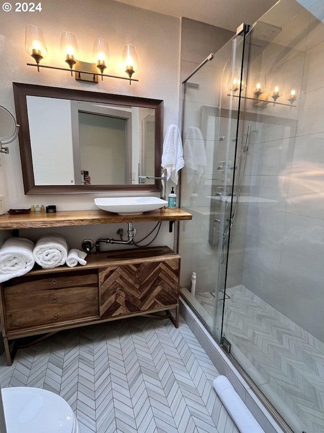 bathroom featuring an enclosed shower, vanity, and toilet