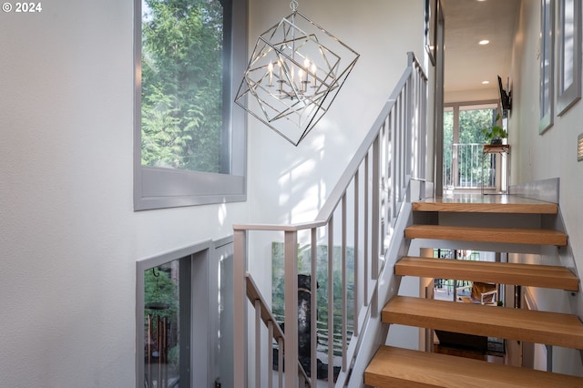 stairs with an inviting chandelier