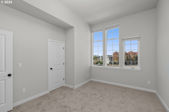 unfurnished room with light colored carpet