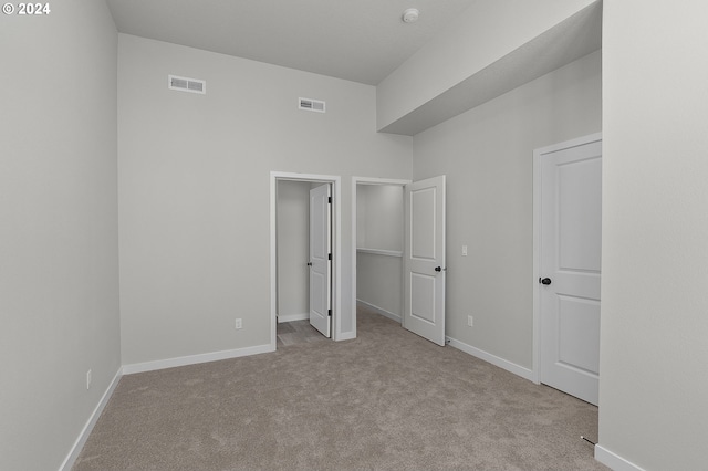 unfurnished bedroom with light colored carpet