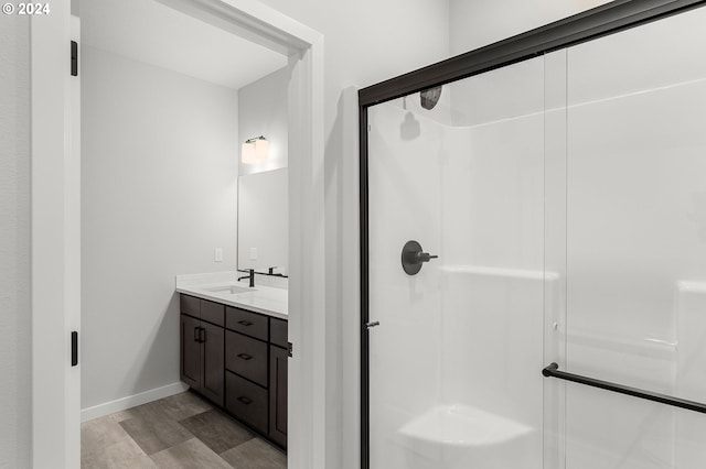 bathroom featuring vanity and an enclosed shower