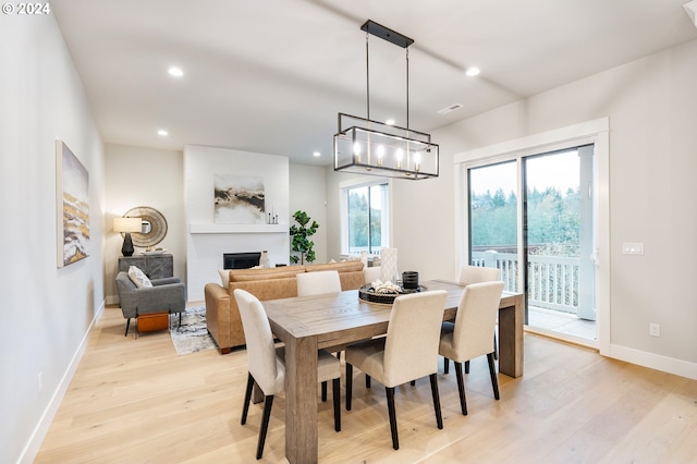 dining room with a chandelier and light hardwood / wood-style floors