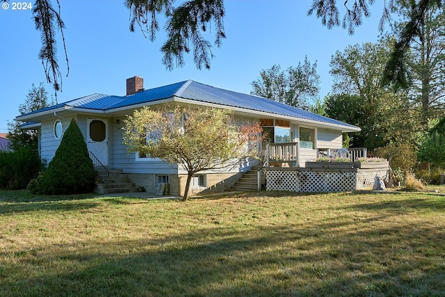 view of home's exterior with a lawn and a wooden deck