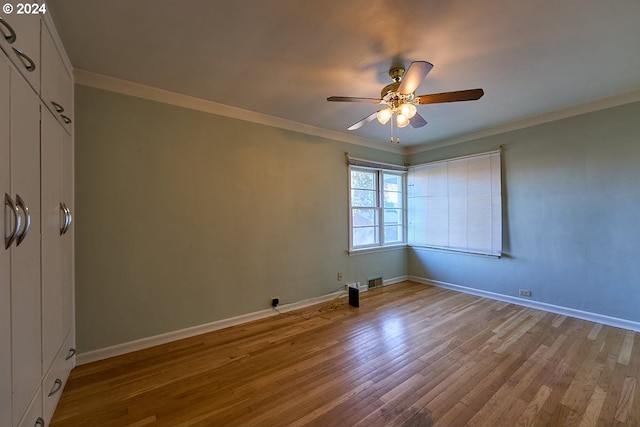 empty room with ceiling fan, ornamental molding, and light hardwood / wood-style floors