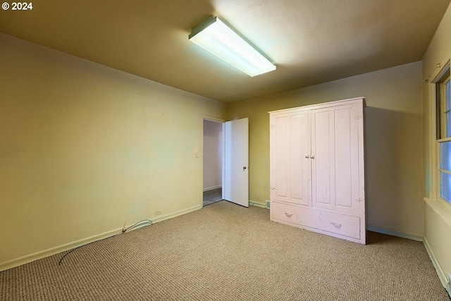 unfurnished bedroom featuring light colored carpet