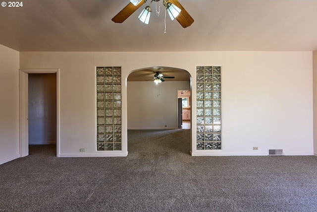 carpeted spare room featuring ceiling fan