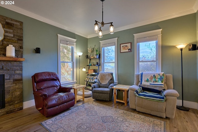 sitting room with ornamental molding, hardwood / wood-style floors, and a healthy amount of sunlight