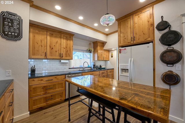 kitchen featuring white fridge with ice dispenser, stainless steel dishwasher, light hardwood / wood-style floors, crown molding, and decorative light fixtures