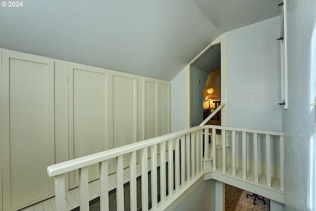 interior space featuring light hardwood / wood-style floors and lofted ceiling