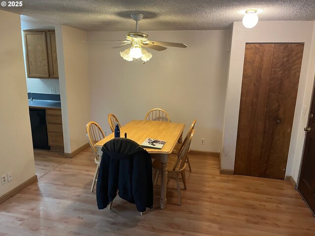 kitchen with light hardwood / wood-style floors, sink, black dishwasher, and stainless steel stove