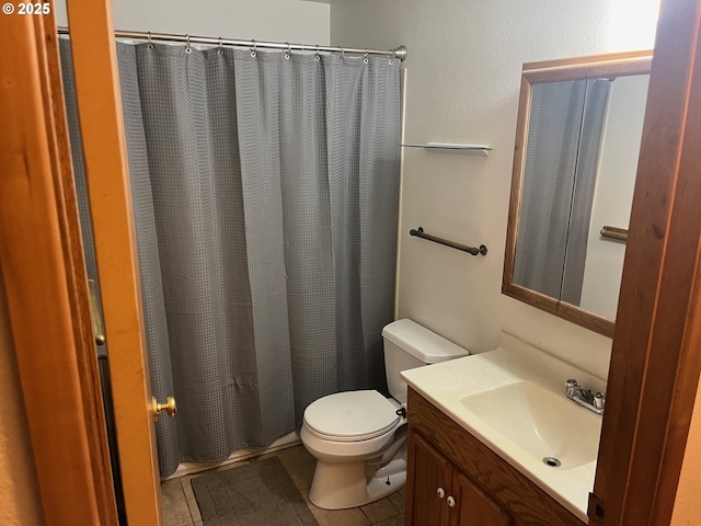 bathroom featuring tile patterned flooring, vanity, toilet, and a shower with shower curtain