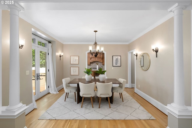 4243 SW Bertha Ave, Portland, OR 97239 - dining room with light wood finished floors, french doors, crown molding, and decorative columns