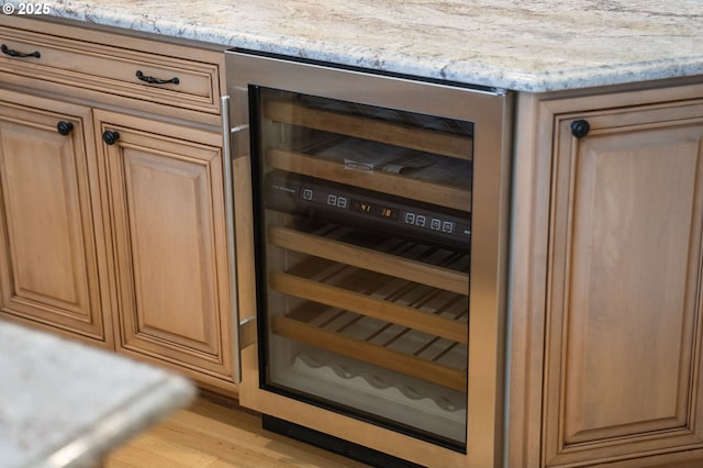4243 SW Bertha Ave, Portland, OR 97239 - detailed view of beverage cooler, light stone countertops, and light wood-style flooring