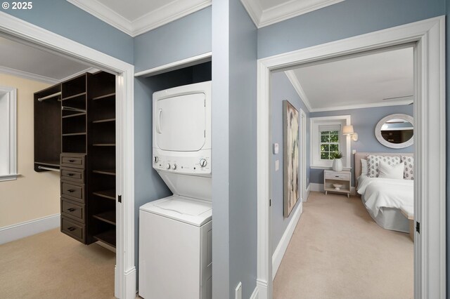 4243 SW Bertha Ave, Portland, OR 97239 - washroom with stacked washer / dryer, carpet, and ornamental molding