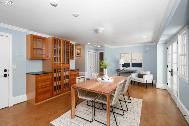4243 SW Bertha Ave, Portland, OR 97239 - dining space with light wood-style flooring, crown molding, and recessed lighting