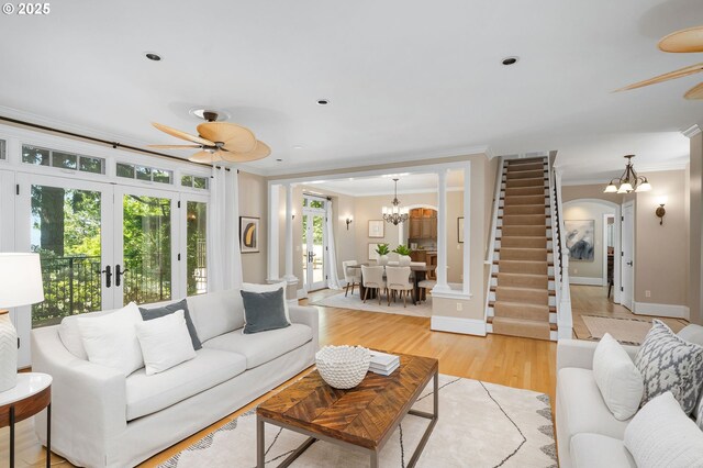 4243 SW Bertha Ave, Portland, OR 97239 - living area featuring ceiling fan, crown molding, a chandelier, french doors, and light wood-type flooring
