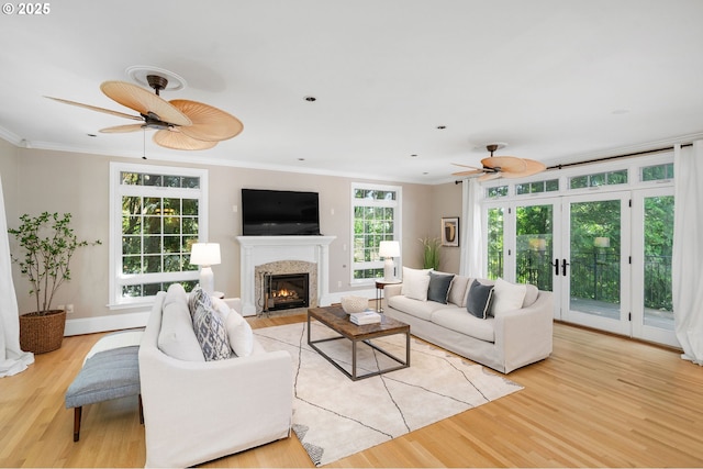4243 SW Bertha Ave, Portland, OR 97239 - living area featuring a ceiling fan, light wood-style flooring, a fireplace, and ornamental molding