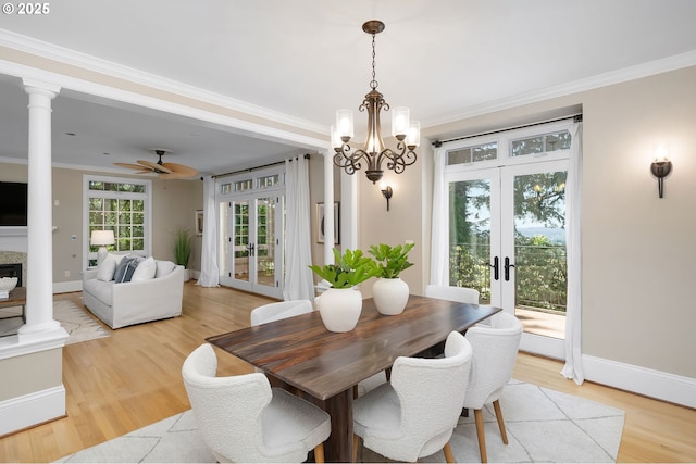 4243 SW Bertha Ave, Portland, OR 97239 - dining room with french doors, light wood-style flooring, crown molding, ceiling fan, and a chandelier
