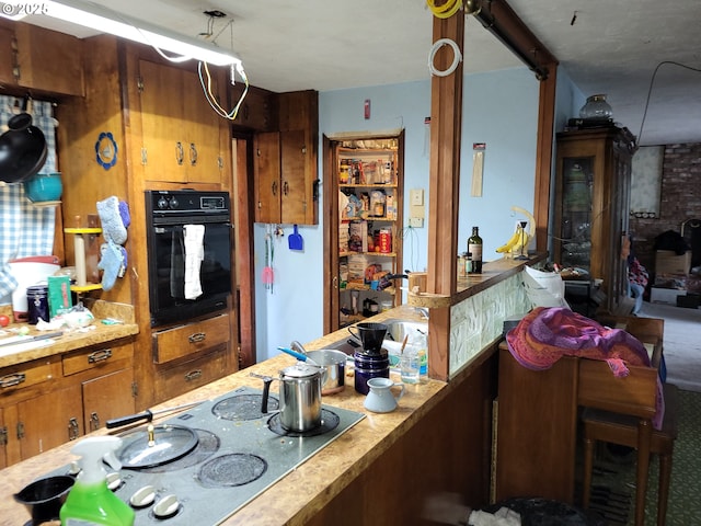 kitchen with stovetop and black oven