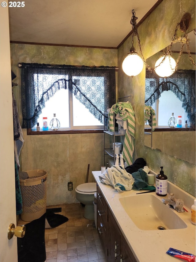 bathroom featuring crown molding, vanity, and toilet