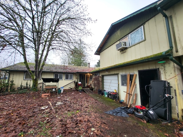 view of side of home with cooling unit and a garage