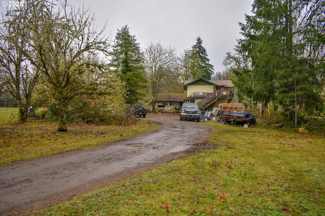 view of front facade featuring a deck and a front yard