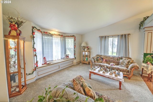 living room featuring lofted ceiling and light colored carpet