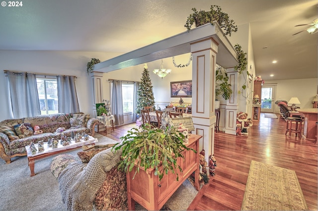 living room featuring hardwood / wood-style flooring, plenty of natural light, and ornate columns