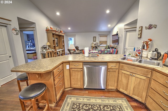 kitchen featuring lofted ceiling, a breakfast bar, sink, dishwasher, and kitchen peninsula