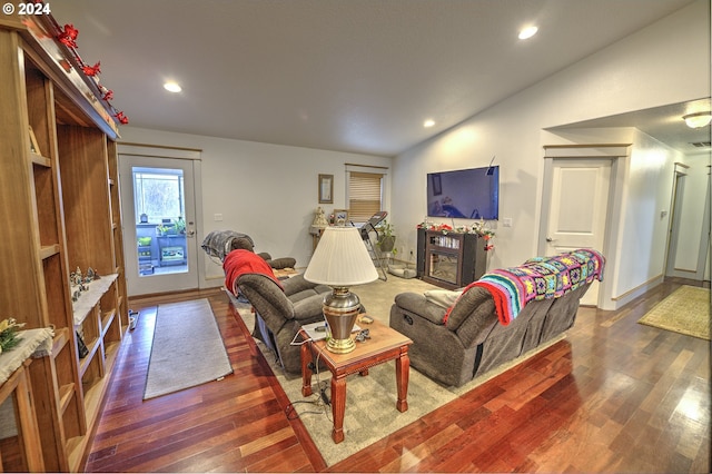 living room with dark wood-type flooring and vaulted ceiling