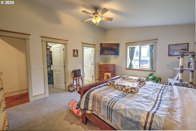 bedroom with ceiling fan, lofted ceiling, and light carpet