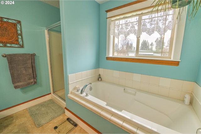 bathroom featuring tile patterned flooring and shower with separate bathtub