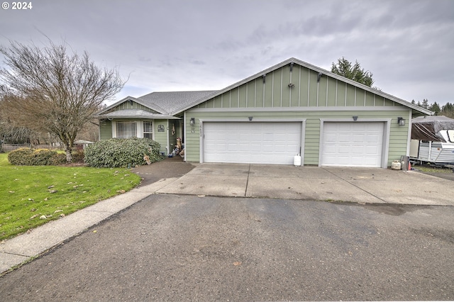 single story home with a garage and a front yard