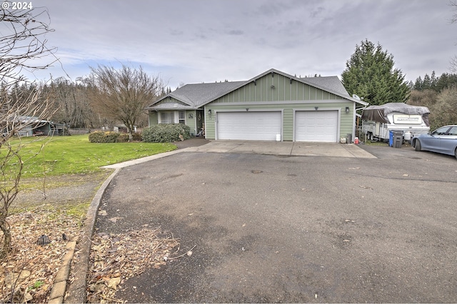 single story home featuring a garage and a front lawn