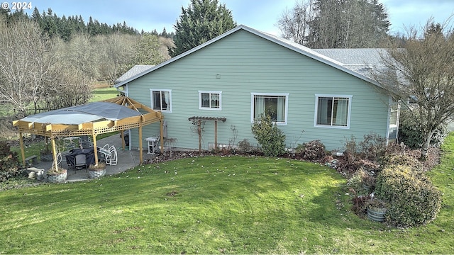 back of house with a yard and a patio area