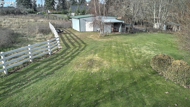 view of yard featuring a rural view and an outdoor structure