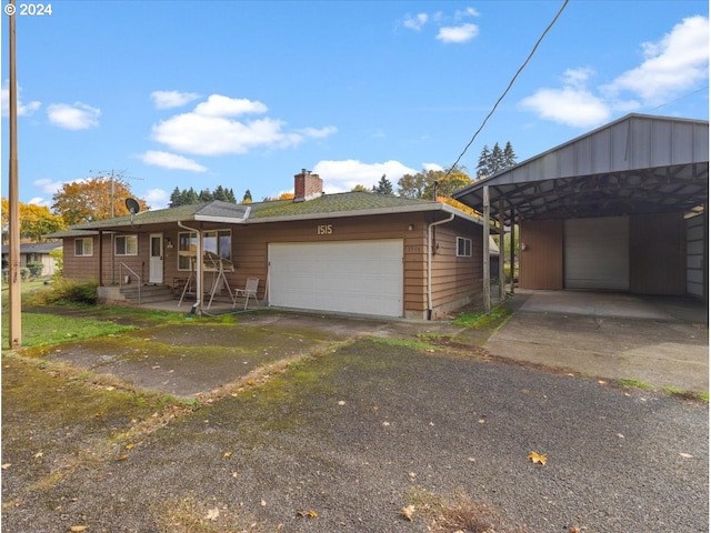 ranch-style home featuring a garage and a carport