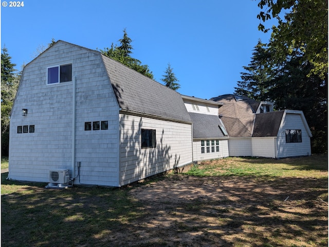 view of home's exterior featuring ac unit, a storage shed, and a lawn