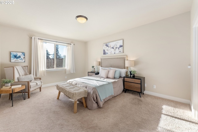 bedroom with baseboards and light colored carpet