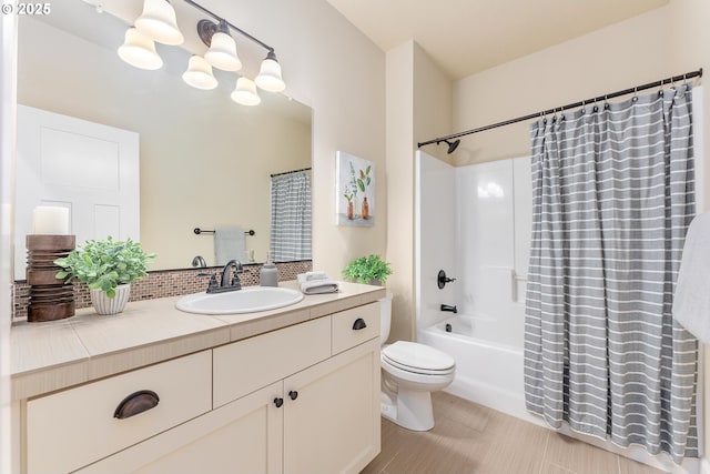 full bathroom with vanity, toilet, shower / bathtub combination with curtain, and an inviting chandelier