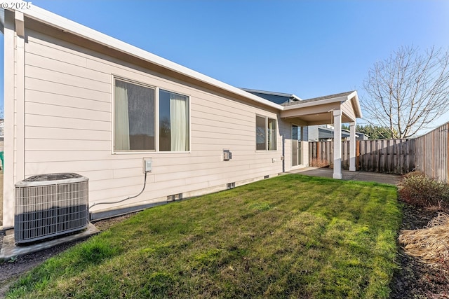 view of property exterior with central AC, a yard, crawl space, and fence