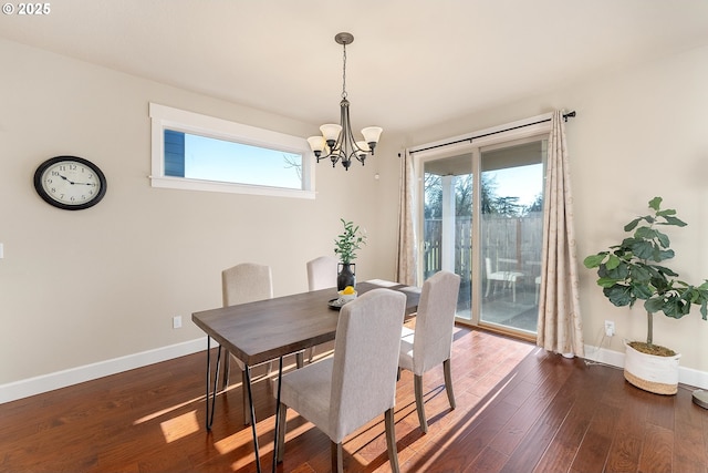 dining area with a chandelier, dark wood-style flooring, and baseboards