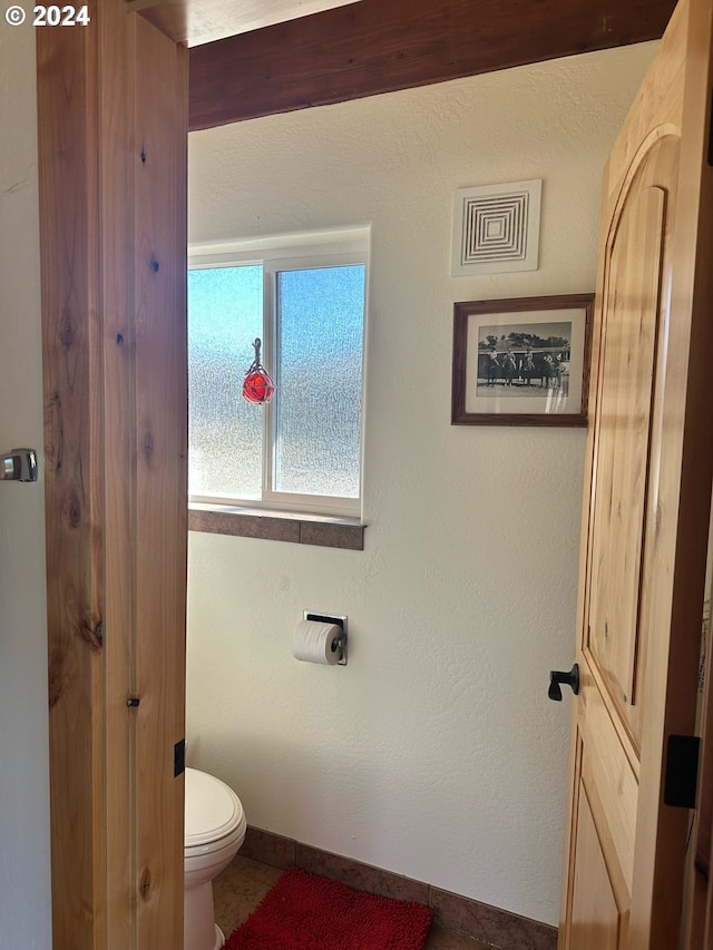 bathroom with tile patterned floors and toilet